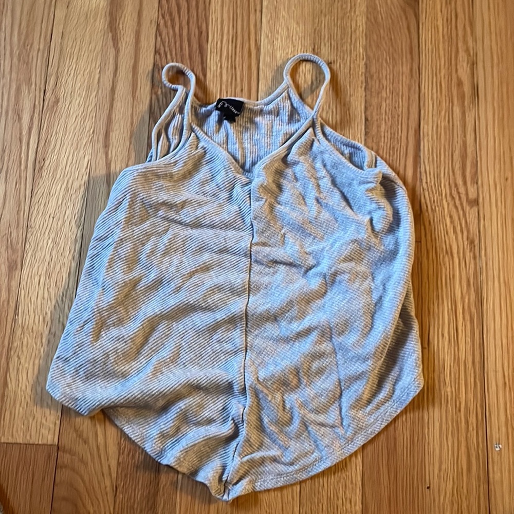 a grey tank top that has a point pointing down.
